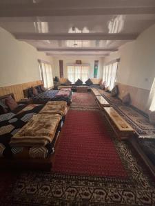 a large room with many beds on the floor at Dungkhar homestay in Kaza +7 photos