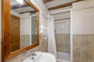 a bathroom with a sink and a mirror and a shower at Cal Vidal in Mura +18 photos