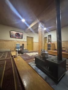 a large room with a stove in the middle at Dungkhar homestay in Kaza