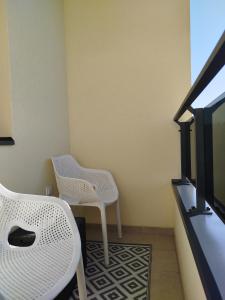 a living room with two chairs and a tv at Studio Sky in Smederevo +4 photos