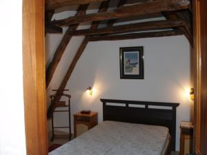 MeyralsにあるLe Clos de Carmensacの梁出し天井のベッドルーム1室(ベッド1台付)