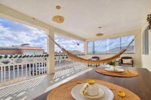 a room with a hammock on a balcony at Lar dos Lençóis BHS in Barreirinhas