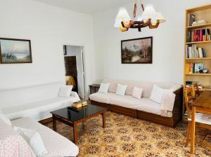 a living room with two couches and a table at Lemon tree's house in Kalavárda