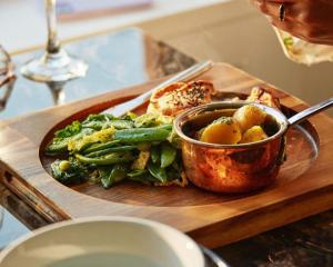 a cutting board with a plate of food on a table at Foyers Lodge in Foyers +23 photos