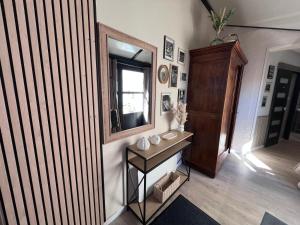 a room with a mirror and a table with a mirror at Jolie maison 5 chambres 20 pers in La Tranche-sur-Mer +2 photos