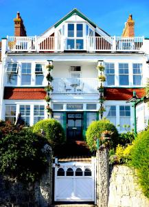 a large white house with a gate in front of it at Poltair Guest House in Falmouth