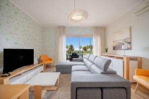 a living room with a couch and a tv at BeGuest Olhão Ria Formosa View in Olhão