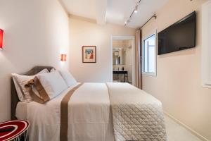 a bedroom with a bed and a tv on the wall at Palazzo Accademia in Florence