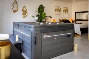 a large metal chest in a room with a bed at Gîte Spa Cookie in Urschenheim