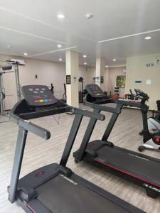 a gym with several tread machines in a room at 131 - Bombas Summer Beach depto 1 dormitorio para 4 con amenities in Bombinhas
