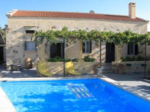 a swimming pool in front of a house at Stathis Villa in Vamos