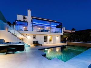 a house with a swimming pool at night at Sara in Les Issambres