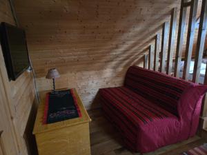 a room with a couch and a tv and a table at Drevenica Goralský Dvor in Ždiar