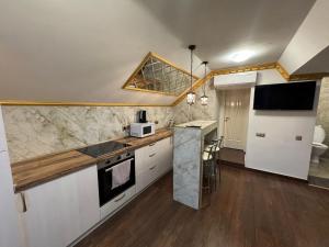 a kitchen with white cabinets and a counter top at Columna Central Park Apt in Chişinău +23 photos