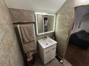 a bathroom with a sink and a mirror at Columna Central Park Apt in Chişinău
