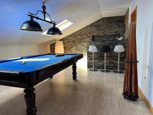 a pool table in a room with a brick wall at Ofir Beach Apartment in Fão