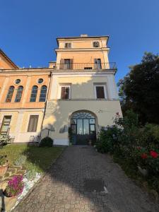 a large building with a tower on top of it at Villa Altieri in Albano Laziale