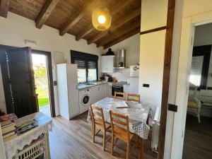 a kitchen and dining room with a table and chairs at APARTAMENTOS LOS MANZANOS in Ribadesella