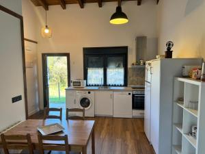a kitchen with a table and a dining room at APARTAMENTOS LOS MANZANOS in Ribadesella +32 photos