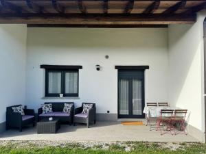 a patio with couches and a table and chairs at APARTAMENTOS LOS MANZANOS in Ribadesella