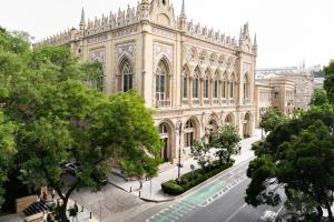a large building with a street in front of it at Green Garden Hotel in Baku