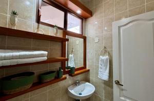 a bathroom with a sink and a mirror at BoHo Galapagos in Puerto Ayora +16 photos