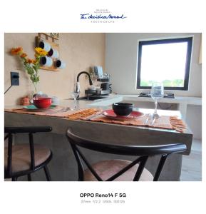 a kitchen with a counter with two wine glasses on it at Casa tierno amanecer in Xpujil