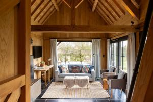 a living room with a couch and a table at De Zonnebrug in Sint-Laureins