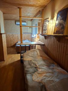 a room with a table and a bed in it at Finstonia Guesthouse in Vääna-Jõesuu