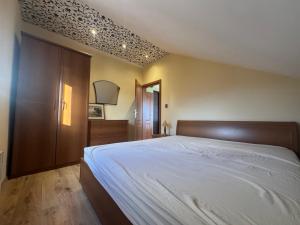 a bedroom with a large bed and a wooden cabinet at Seaview Tivat in Tivat