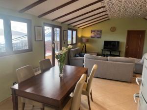 a living room with a wooden table and chairs at Seaview Tivat in Tivat