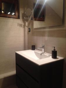 a bathroom with a white sink and a mirror at Seaview Tivat in Tivat +7 photos