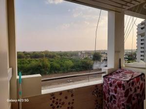 a large window with a view of a city at The Pinnacle Retreat , Jaitala in Nagpur