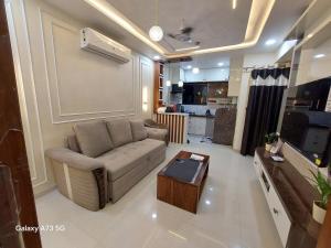 a living room with a couch and a coffee table at The Pinnacle Retreat , Jaitala in Nagpur