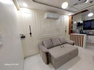 a living room with a couch and a kitchen at The Pinnacle Retreat , Jaitala in Nagpur