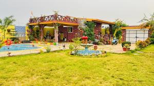 a house with a pool and a fountain in the yard at Palash Paradise in Bokāro