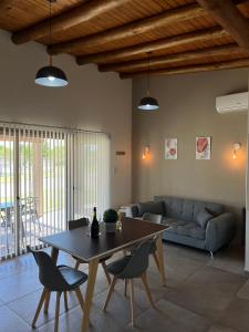 a living room with a table and chairs and a couch at ARAUCARIA Resort in San Rafael
