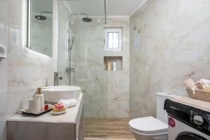 a bathroom with a shower and a toilet and a sink at Hara's Cozy Apartment with Private Parking in Rhodes Town +19 photos