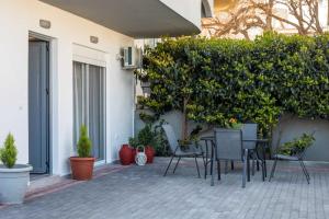 a patio with a table and chairs and plants at Hara's Cozy Apartment with Private Parking in Rhodes Town