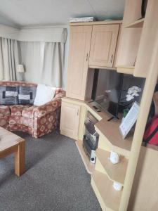 a living room with a couch and a table at 2 Vale Park in Fishguard