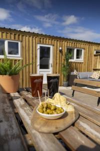 a bowl of fruit sitting on a wooden table at Cheviot Glamping Ltd in Ford +48 photos