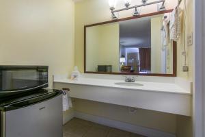 a bathroom with a sink and a mirror at Calloway Inn and Suites in Hammond