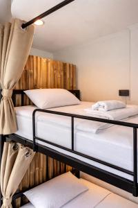 two bunk beds in a room with wooden walls at SEVEN Guesthouse in Thong Sala
