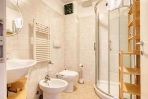 a bathroom with a sink and a toilet and a shower at Linate Airport - Apt with Garden in Milan +15 photos