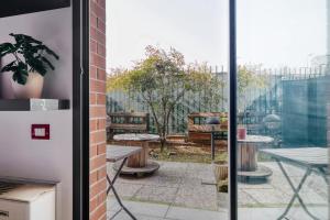 a view of a patio through a glass door at Linate Airport - Apt with Garden in Milan