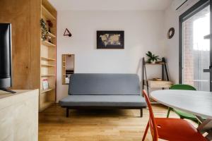 a living room with a blue couch and a table at Linate Airport - Apt with Garden in Milan