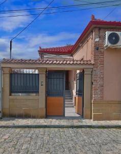 a brick house with a red roof at Villa Luarasi in Korçë