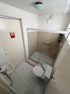 a bathroom with a shower and a toilet and a sink at Pousada Extensão Sabrinna in Maceió