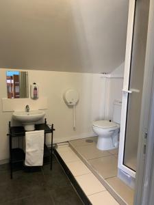 a bathroom with a sink and a toilet at Meeting Hostel in Figueira da Foz +44 photos