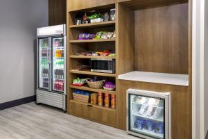a kitchen with a refrigerator and a microwave at Holiday Inn Quincy by IHG in Quincy
